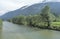 Wide cold water river in mountain landscape