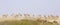 A wide-cropped view of springbok atop a dune near a water-hole in the Etosha Wildlife Reserve in Namibia.