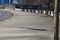 A wide curved sidewalk near the street lined with bare winter trees along the sidewalk and a metal fencing in downtown Atlanta