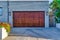 Wide dark brown wooden door of attached garage of house in San Diego California