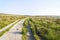 Wide dirt road going across moorland