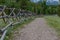 Wide Dirt Trail Along Wooden Fence