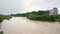 Wide dirty river with muddy water in flooding period during heavy rains in spring.