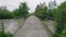 Wide dirty river with muddy water under the bridge across the river in the village in flooding period during heavy rains