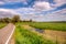 Wide ditch with duckweed in a beautiful green meadow landscape w