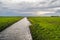 Wide ditch in a Dutch polder landscape