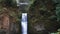 Wide down tilt of the lower step of Multnomah Falls in Portland