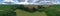 Wide drone aerial panoramic view on agricultural landscape with swamp pond, trees, fields and meadow
