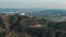 Wide drone footage over hills and mountains near Los Angeles, California on sunny day