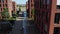 Wide drone shot flying over pedestrians walking over a path on a company or university campus