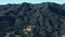 Wide drone shot over hills and mountains in Santa Barbara County, California on sunny day