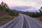 Wide empty highway with curve in the morning. Travel and destination background. Free asphalt road with mountain background.