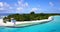 Wide flying island view of a sandy white paradise beach and blue water background in colourful 4K