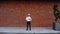 Wide frame in front of a handsome Caucasian worker with a helmet, standing outdoors.