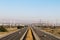 A wide full angle view overlooking multiple lanes of california freeway interstate highway traffic with desert and blue sky