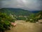 Wide Ganga river having mountains all around with clouds in the sky in Rishikesh India