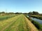 Wide grassy path by river