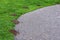 Wide gravel path curved through grass and lined by mole hills