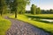 wide gravel path winding through a serene meadow