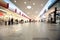 Wide hall and buyers in trading centre with shops