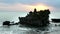 A wide high angle shot at sunset of tanah lot temple on the island of bali