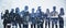 Wide image of business people silhouettes standing on abstract night city background. Teamwork and communication concept. Double