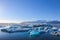 Wide landscape of icebergs floating on the water under the very clear blue sky with copy space