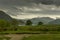 Wide landscape of Lake District in rain storm.