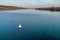 A wide large river, a white buoy floats on the water.