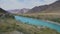 Wide Mointain River With Blue Water Slowly Flowing With The Mountain Range Beautiful LAndscape View