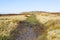 A wide muddy footpath leads up to Stanage Edge