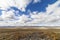 Wide open empty desert landscape in Nevada during winter with blue skies and clouds.