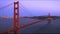 Wide pan of golden gate bridge and san francisco city at dusk