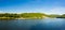 Wide panorama of Cheat Lake on a summer evening with boats docked in marina