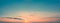 Wide panorama of the dawn sky. Bright sun with small clouds in the sky.