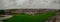 Wide panorama of Derry or Londonderry on a cloudy day viewed from the city walls. Green panorama of the city, residental houses