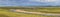 Wide panorama of a meandering river in the tundra in the Arctic.