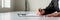 Wide panorama view of businessman hand signing legal or insurance document