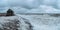 Wide panoramic view of dramatic seascape with a raging White sea and a fishing hut on the shore. Kandalaksha bay. Umba. Russia