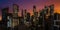 Wide panoramic view of a futuristic downtown cityscape with skyscraper buildings lit up at sunset. 3D rendering