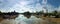 Wide panoramic view of the thames at kew brige with houseboats and surrounding buildings