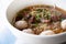 wide rice noodle soup with vegetables and beef