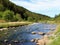 Wide river flowing through the green landscape