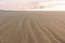 Wide sandy beach while outflow. Atlantic Ocean beach on sunset. Marine lanscape. Scenic sand beach in evening.