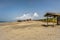 Wide sandy beach under blue skies with scattered clouds