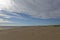 The wide sandy deserted beach of Tentsmuir Point on the southern edge of the Tay Estuary under a Big Sky in August.