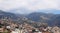 Wide scenic panoramic aerial cityscape of the city of funchal in Madeira with buildings of the city in front of mountains with