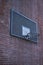 Wide shot of an angle of a basketball ring on a brick wall of a building