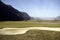 Wide shot of a beautiful blue monster golf course in South Tyrol, Italy surrounded by mountains