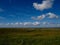 Wide shot of a beautiful field scenery with relaxing cloudscape